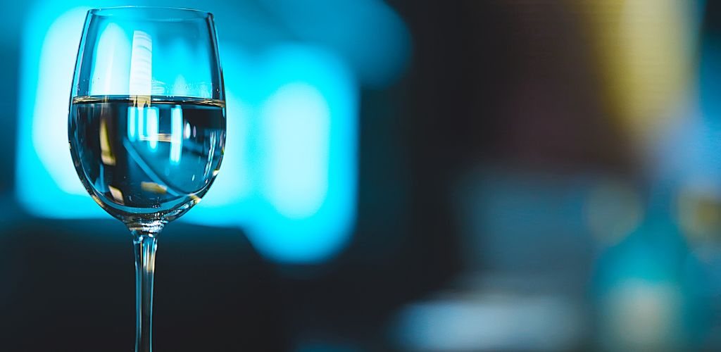 Wine glass with blue light background.