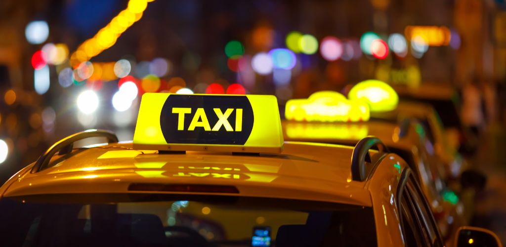 Yellow taxi cabs and blurred city lights background at night with colorful bokeh