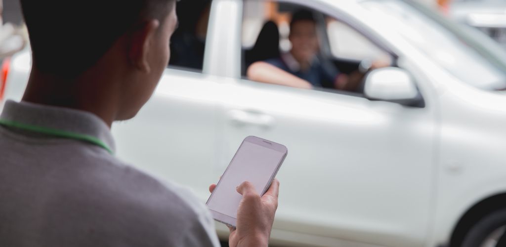 The customer Ordering an uber car via Online Apps on his mobile phone. 