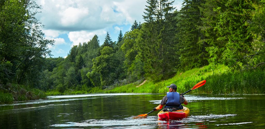 Man Riding on Red Kayak on River