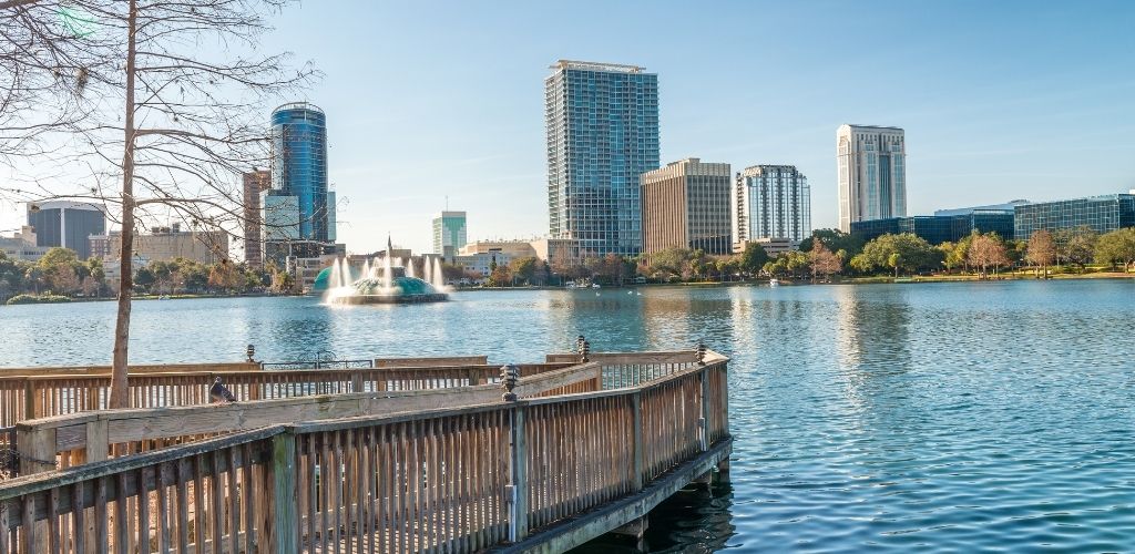 lake eola park in orlando on a fall day with skyscrapers in the distance