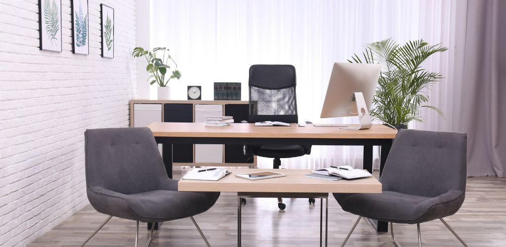  Office with Large Wooden Table. Interior Design, personal computer, notebooks on the table, and indoor plant