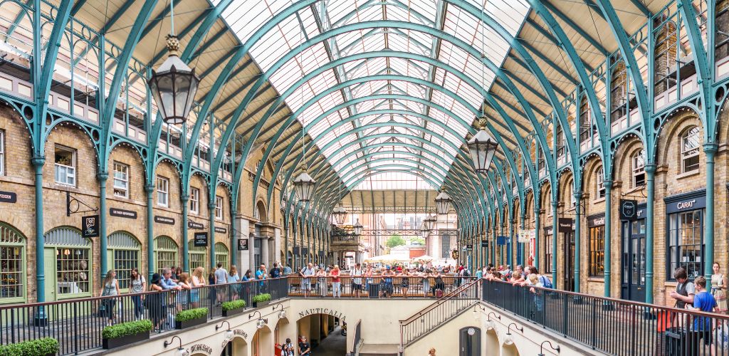 People inside the enclosed garden with a dome-shaped ceiling. 