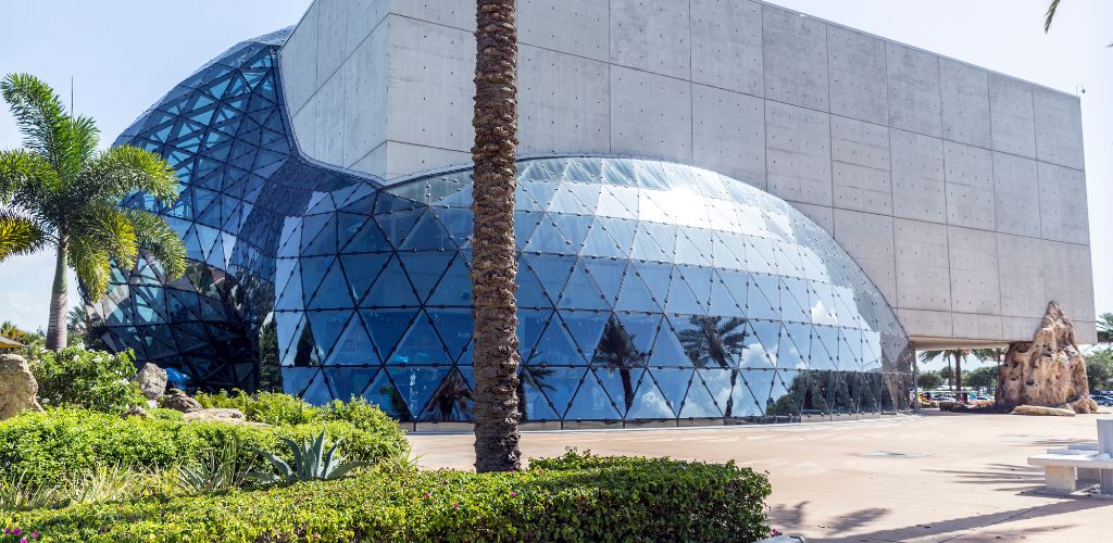 A dome-shaped building structure built of cement and glass, with an outside garden. 
