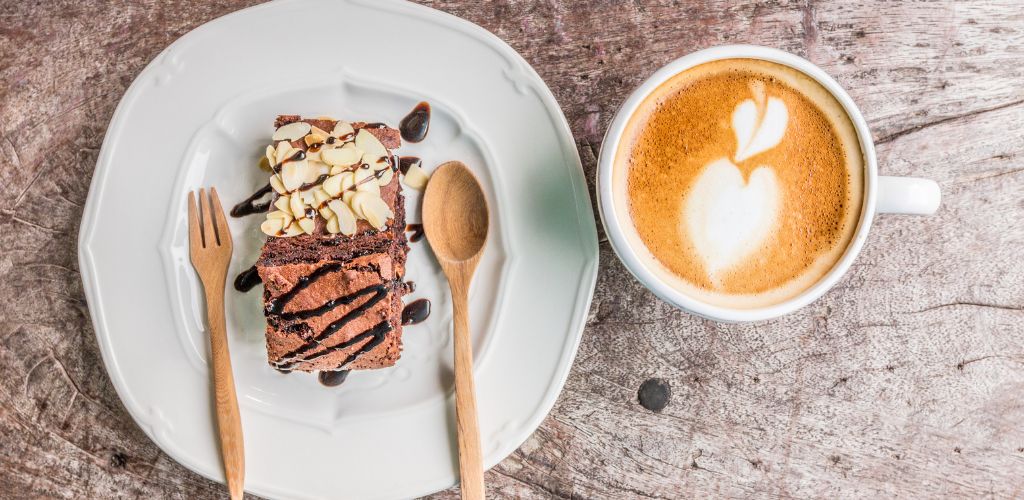 coffee with brownie cake on wood background