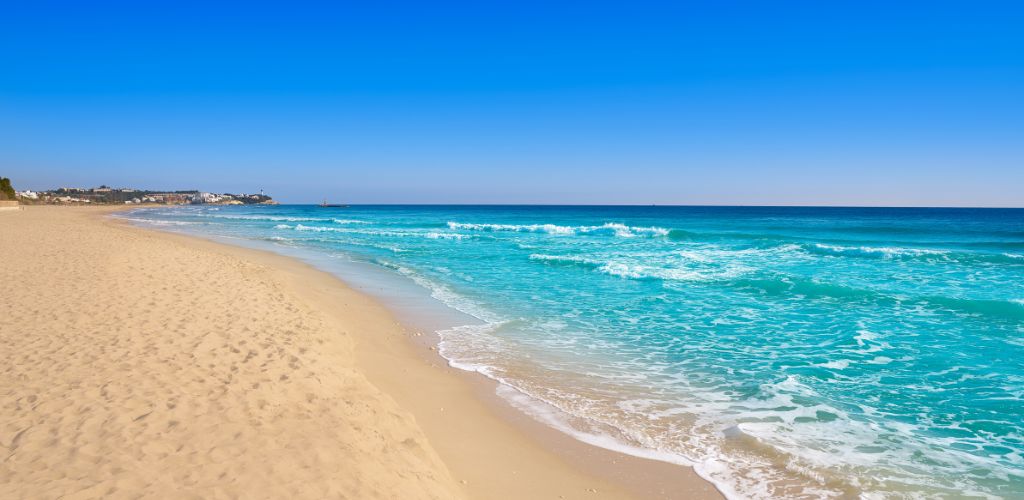 White sand, clear blue sea, and clear blue sky. 