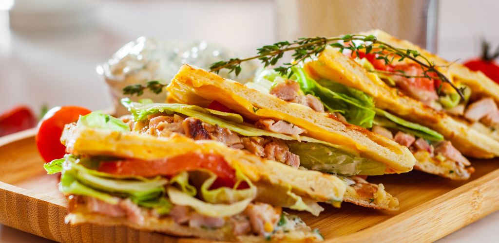 Skepasti: greek gyros with meat, tzatziki sauce, vegetables, cheese and french fries on wooden plate