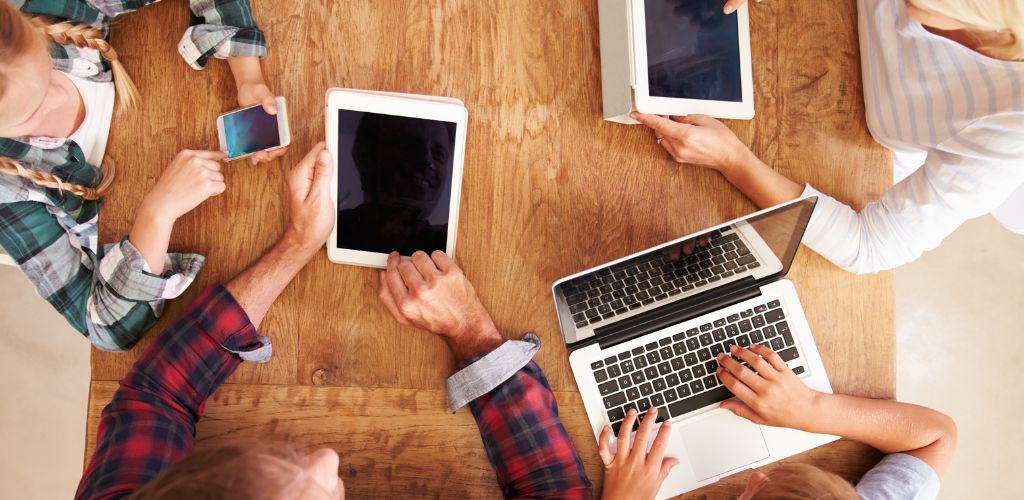 Group of people using new technology overhead view. 