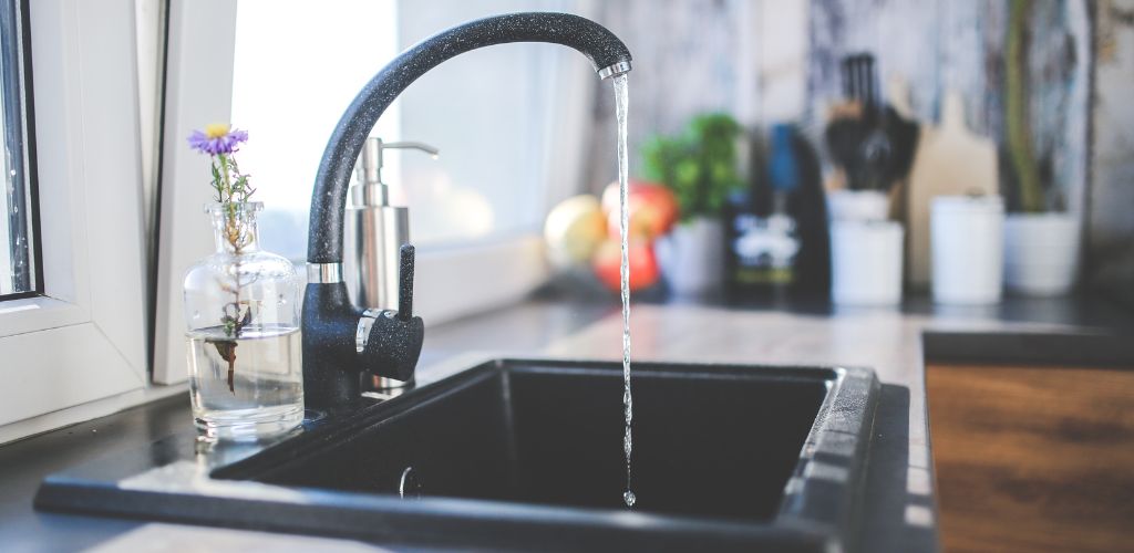 Water flows from the tap to sink