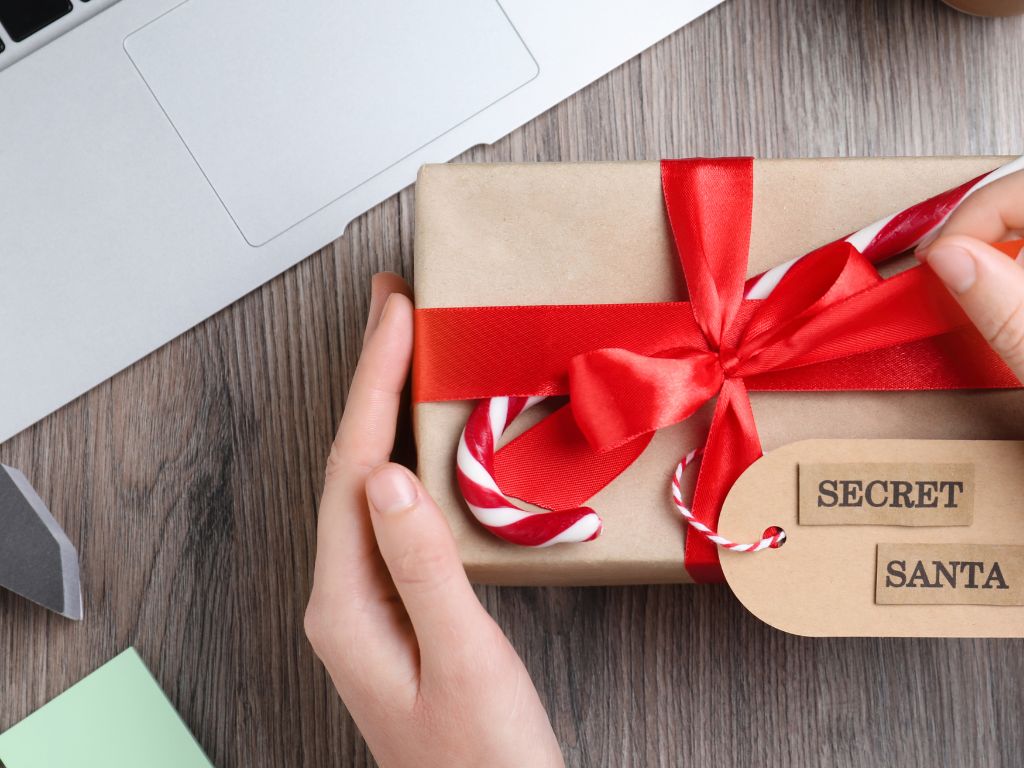 A digital nomad opening a gift on their desktop with their laptop