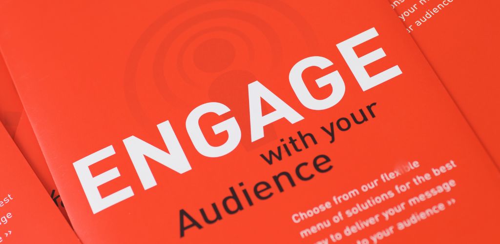 A booklet with the note " Engage with your audience"