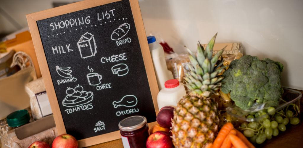 Grocery shopping list on a board in the kitchen. 