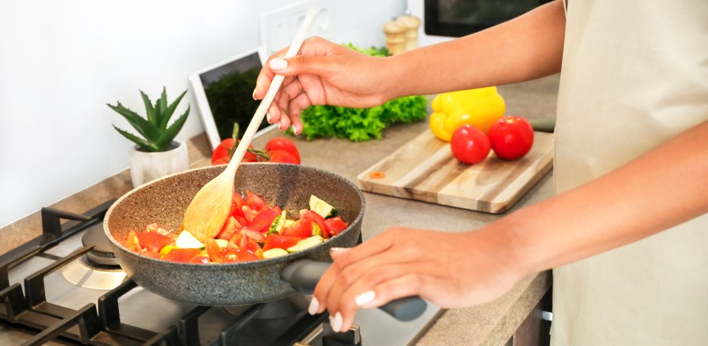 person cooking at home Mediterranean food with frying pan