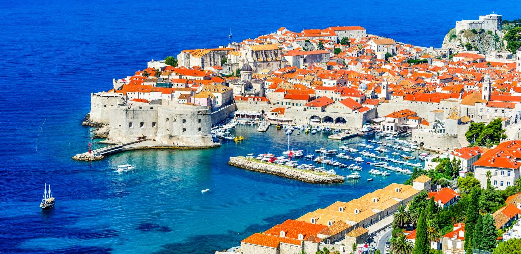 Aerial view of Croatia, port city with white building houses and terracotta roofing 