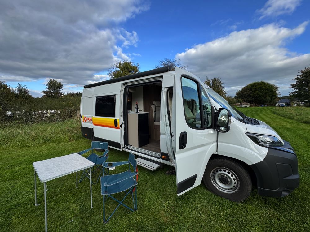10 Day Campervan Trip in Ireland (Our Itinerary & Experience) outside campervan with doors open